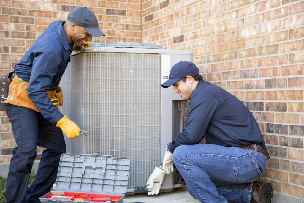 AC installation with two HVAC technicians