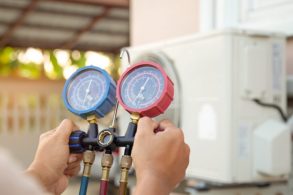 HVAC technician checking refrigerant pressure