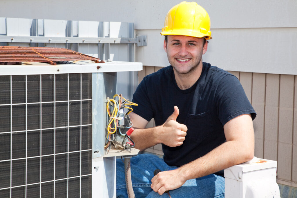 HVAC technician repairing condenser